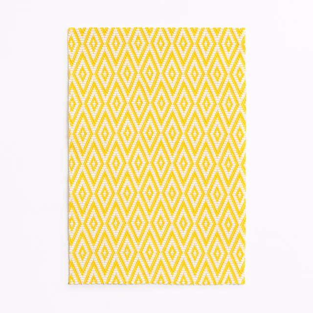 Lemon yellow and white woven fabric with repeating diamond and zigzag geometry