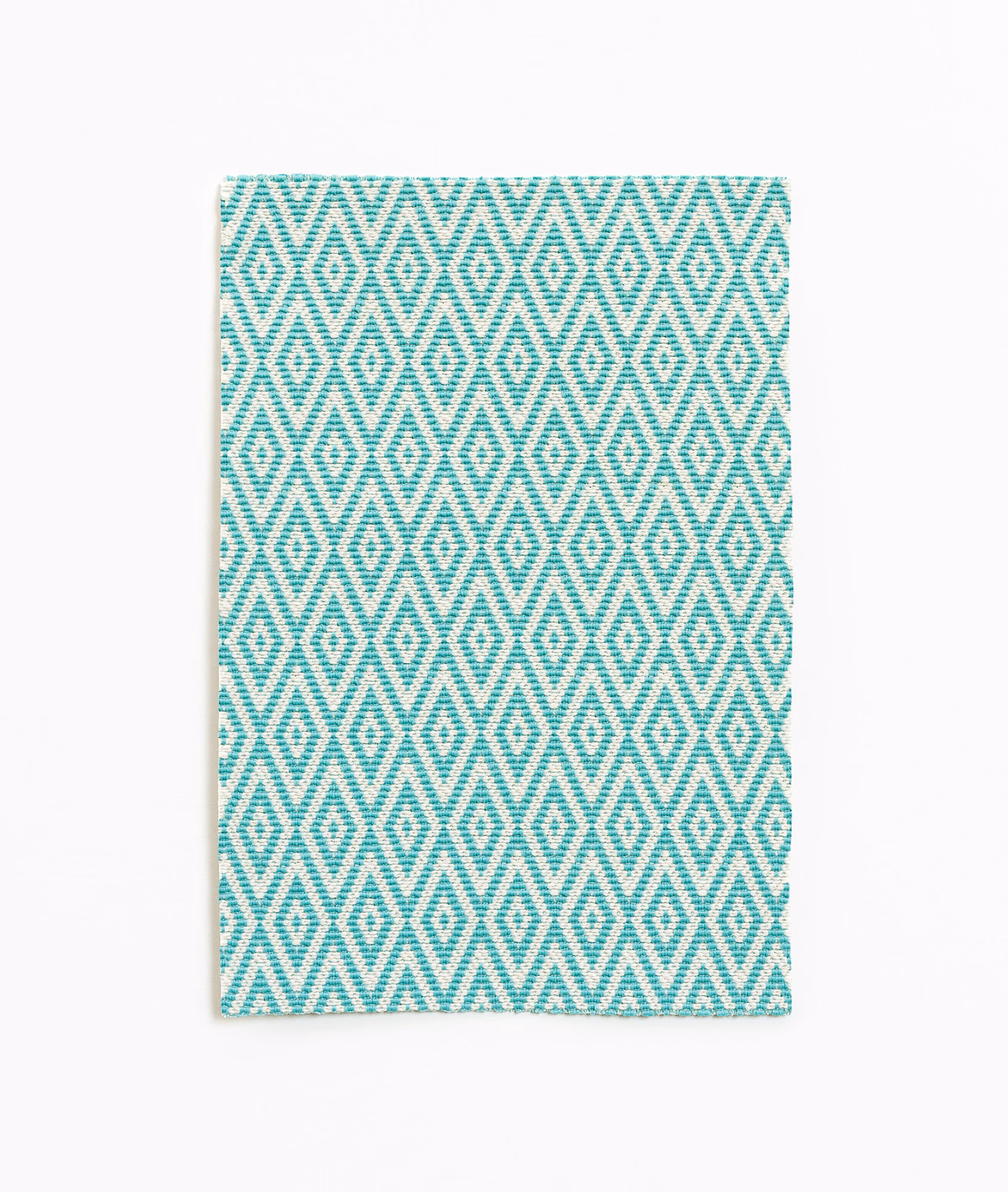 Cool turquoise and white woven diamond pattern with repeating zigzag lines