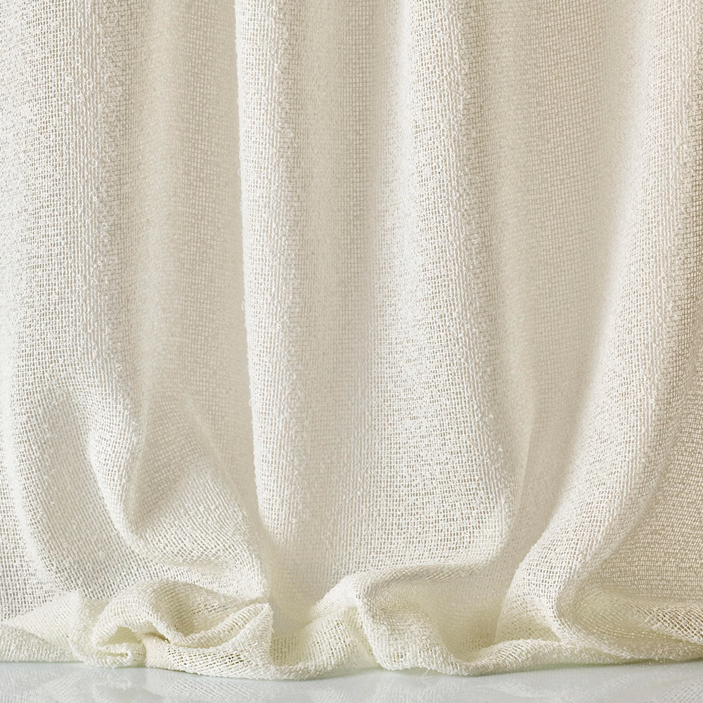 Warm ivory open-weave fabric gathered into softly shadowed vertical folds