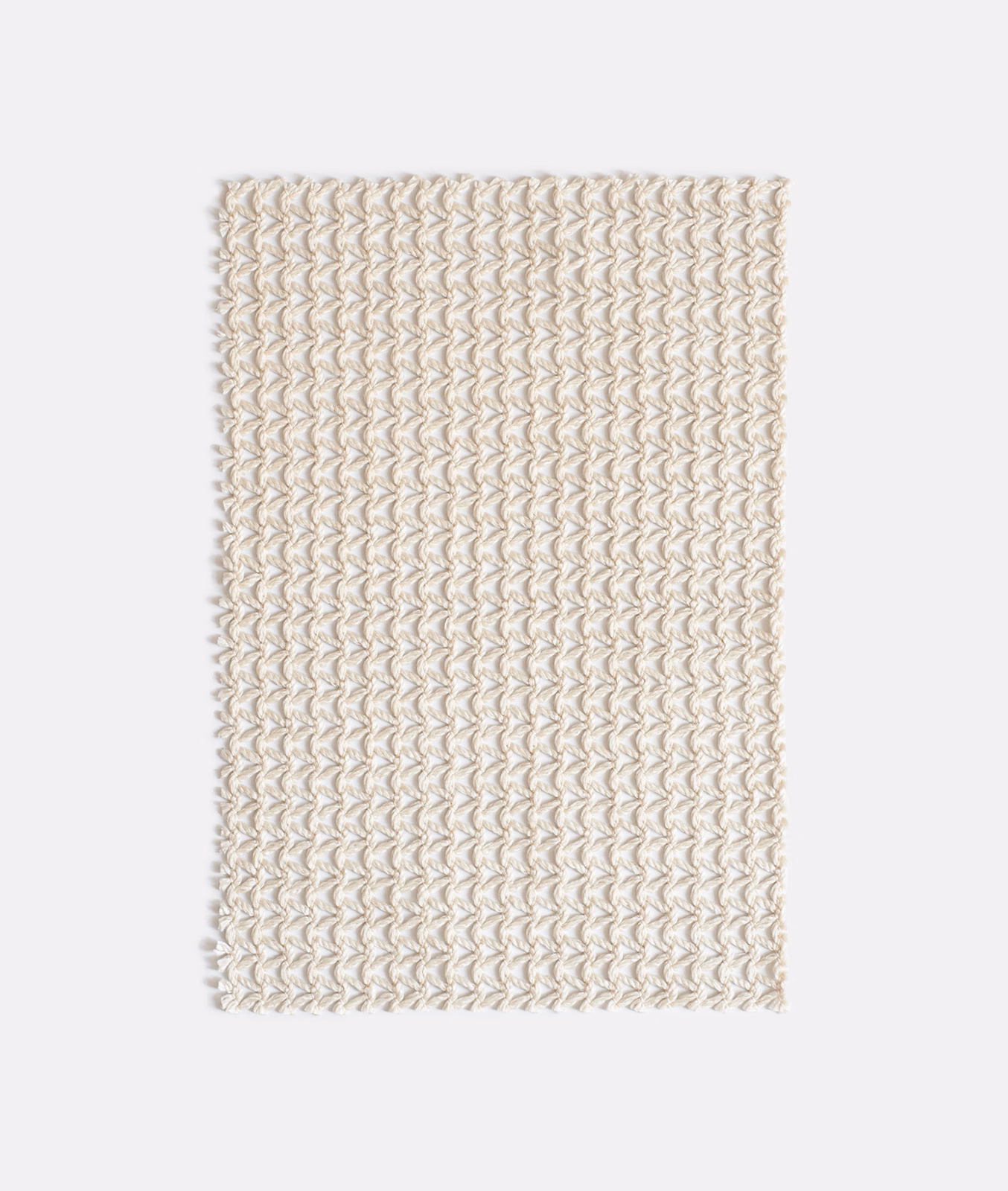 Warm ivory outdoor textile with rows of raised, looping corded motifs