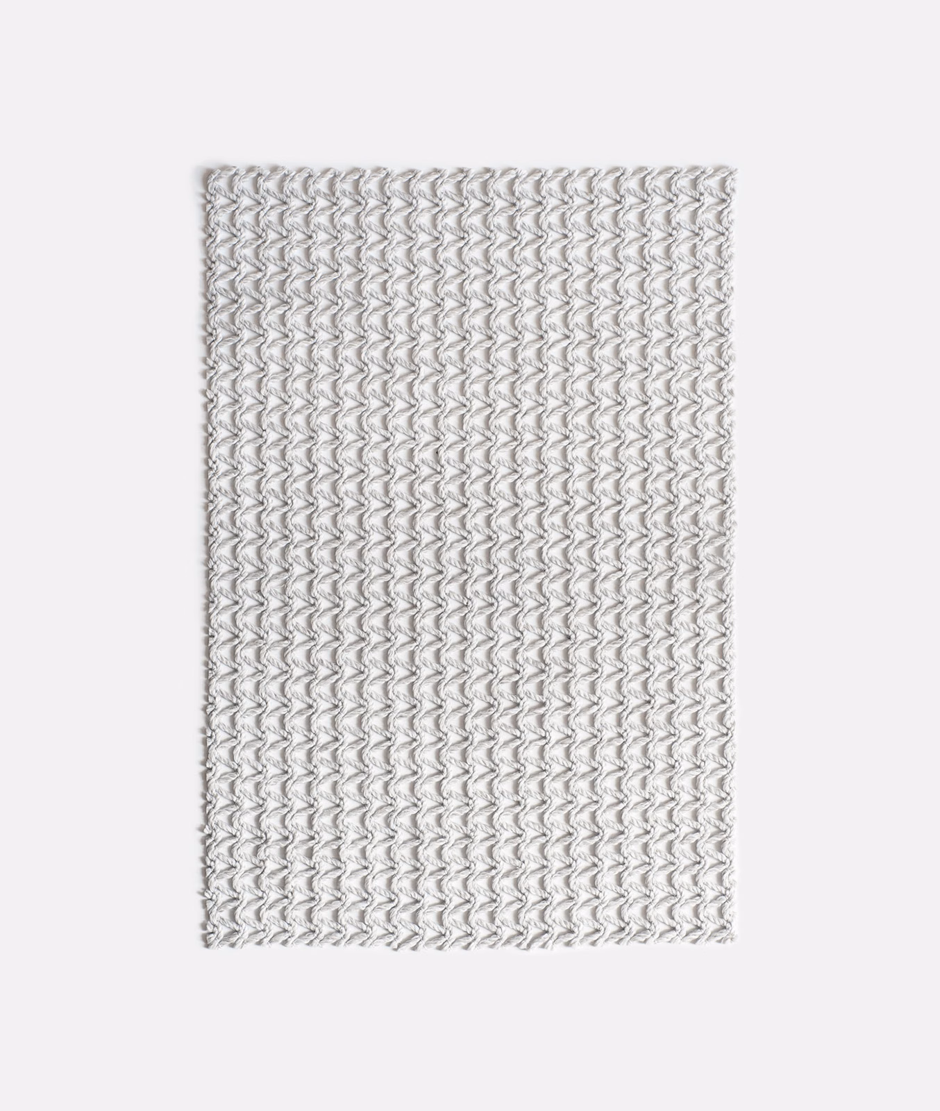 Pale grey woven swatch with tightly repeated undulating chevron lines and fine texture