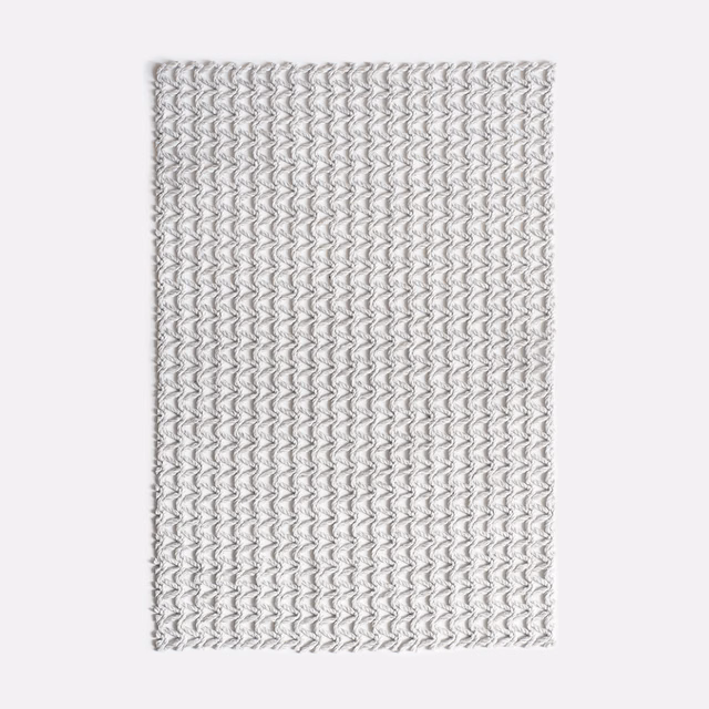Pale grey woven swatch with tightly repeated undulating chevron lines and fine texture