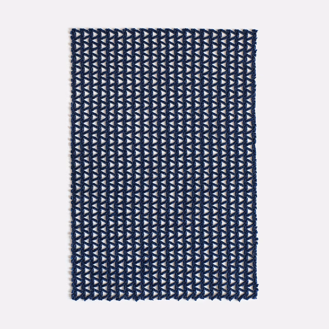 Deep navy woven swatch with repeating pale blue-grey arrowhead motifs