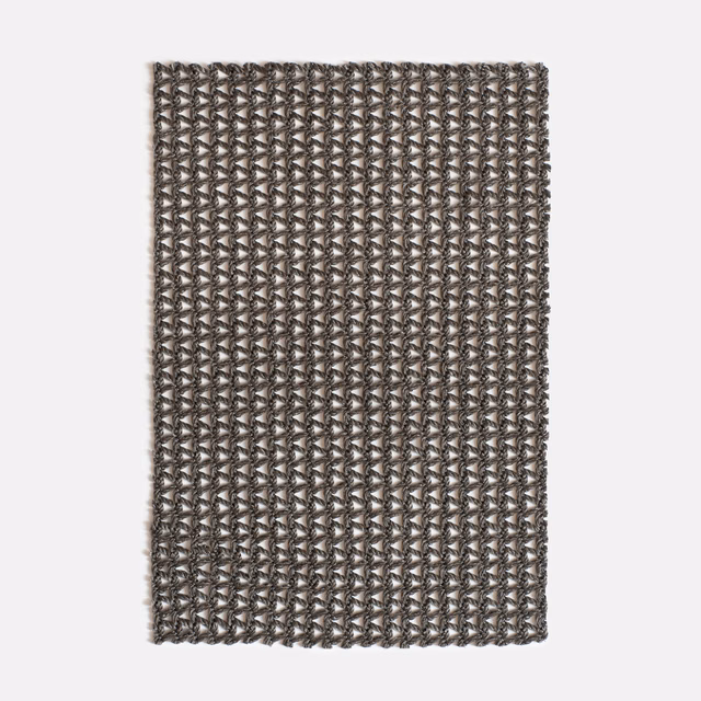 Dense taupe-grey weave with repeating miniature chevrons and contrasting flecked threads
