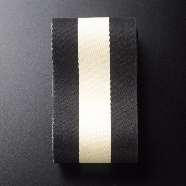 Black and ivory vertical ribbon stripes on a subtly textured woven swatch