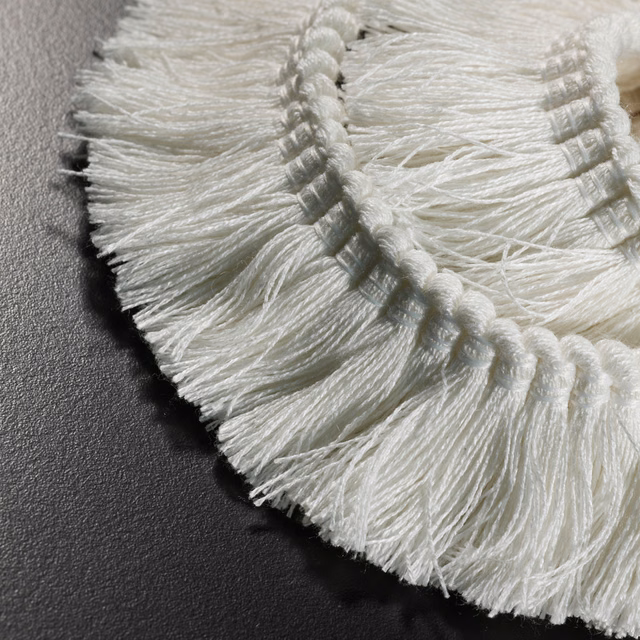 Soft ivory braided fringe with long fine strands in close-up