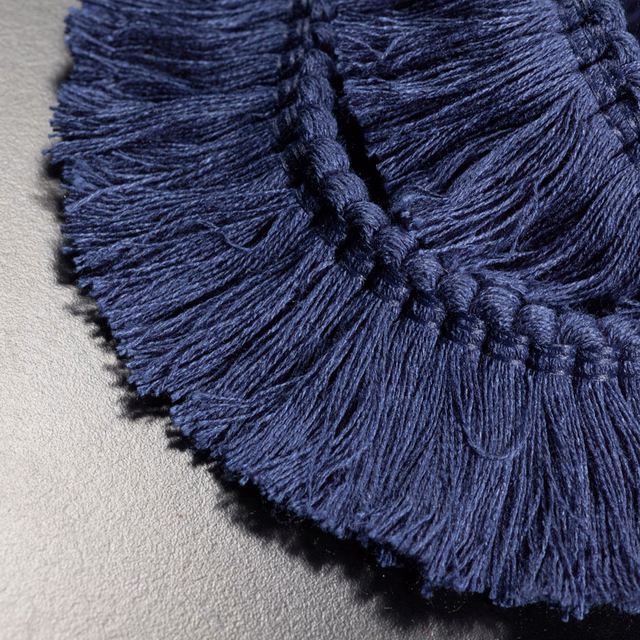 Close-up of deep navy fringe with braided cord and fine radiating strands