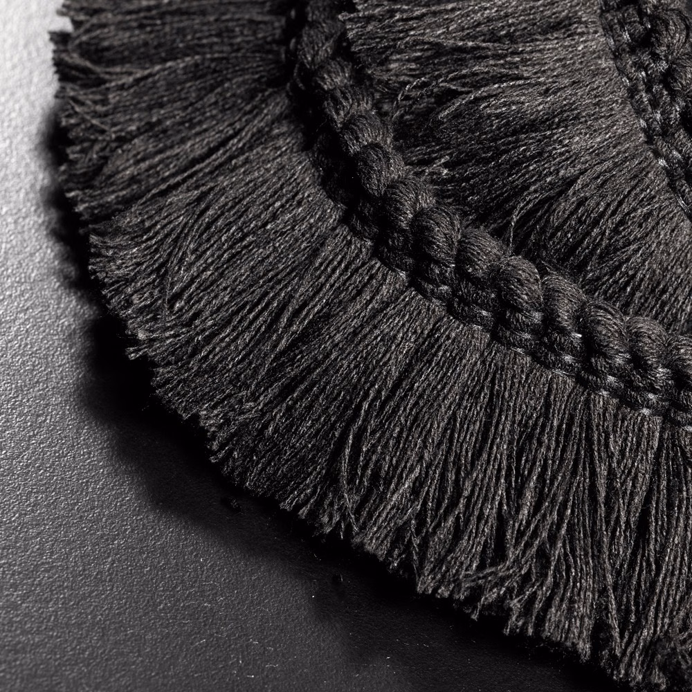 Close-up of dense charcoal-black fringe with a raised braided trim edge