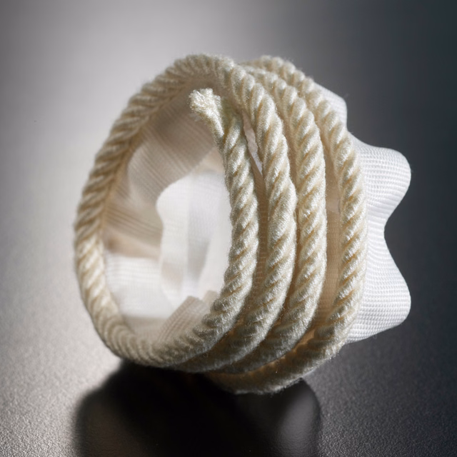 Warm ivory twisted lipcord with raised spiral texture over a pale woven ground