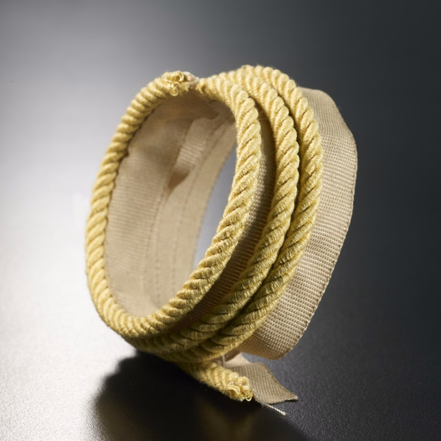 Soft straw-yellow braided lipcord loop with pale woven backing and pronounced ridged texture