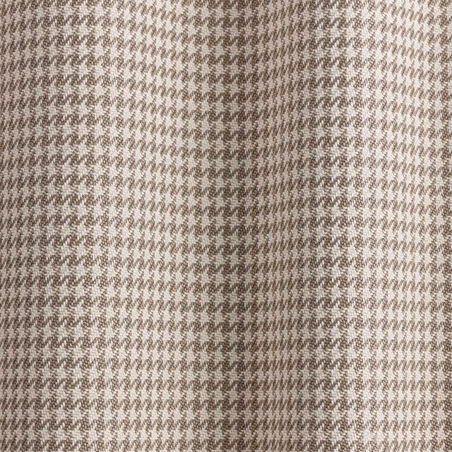 Close-up of beige and taupe woven micro-houndstooth fabric with softly textured surface