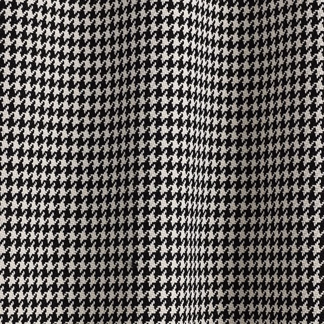 Close-up of black and white houndstooth weave with softly varied tonal texture