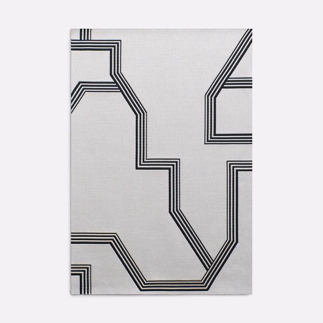 Pale grey jacquard with bold black stepped geometric lines and subtle woven texture