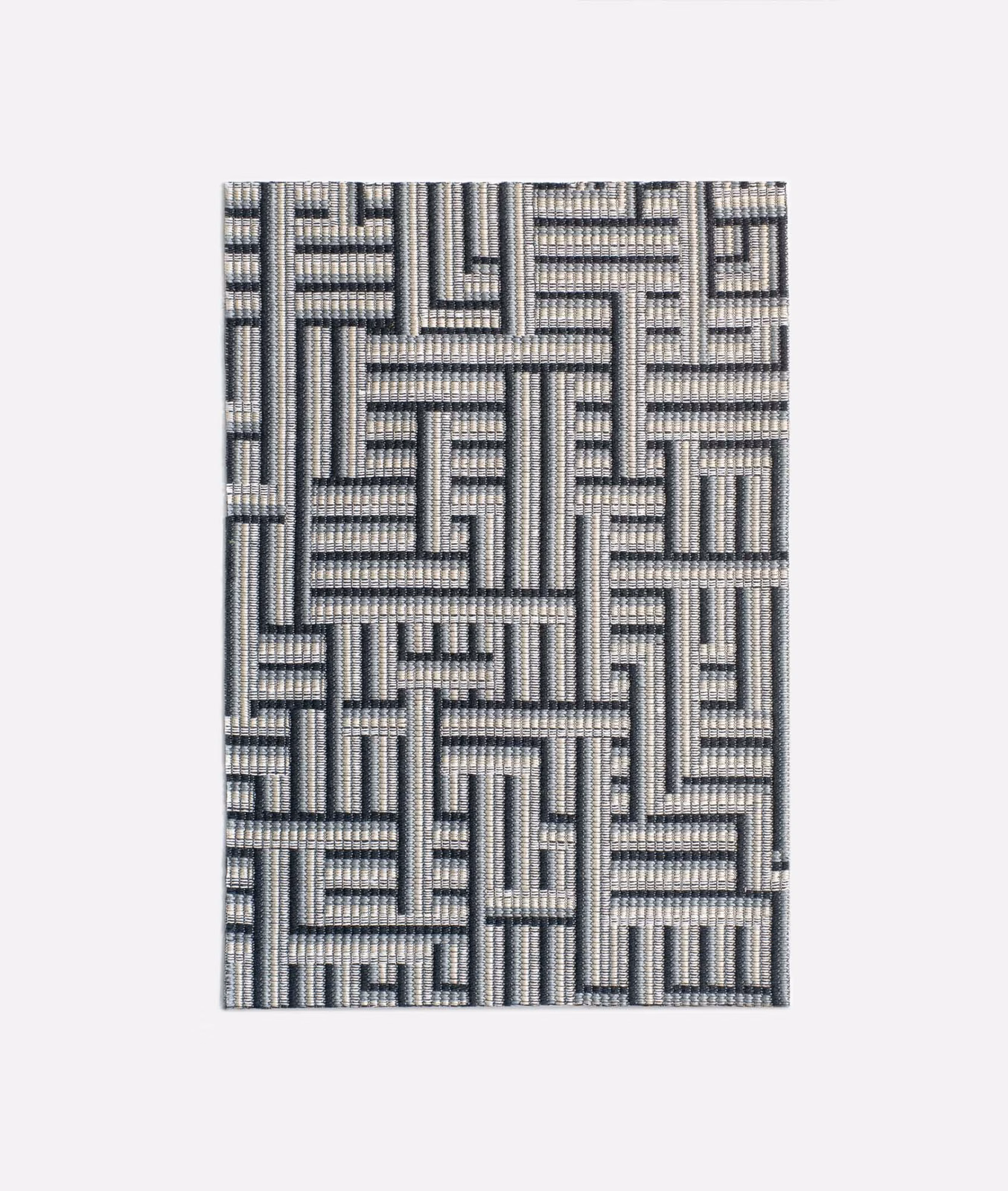 Cool cement-grey jacquard with a charcoal interlocking maze pattern and tactile weave