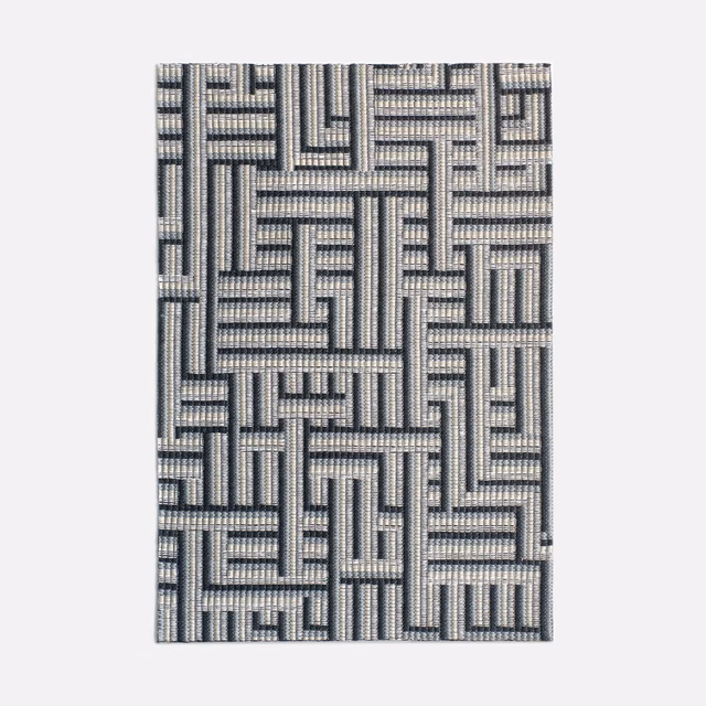 Cool cement-grey jacquard with a charcoal interlocking maze pattern and tactile weave