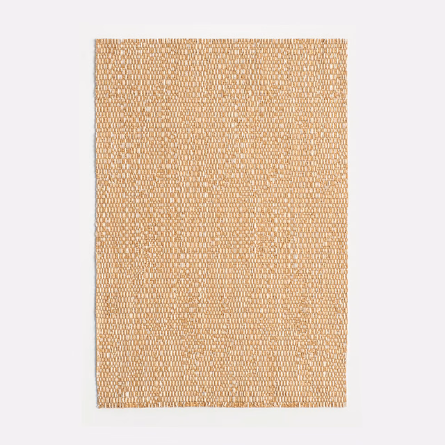Warm camel jacquard swatch showing a dense, small-scale looped weave