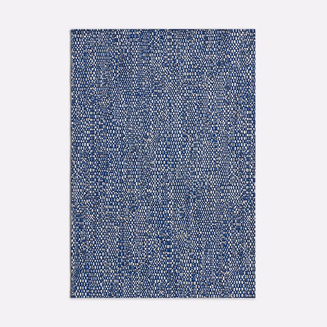 Dense deep-blue jacquard with tiny cream flecks and softly mottled woven texture