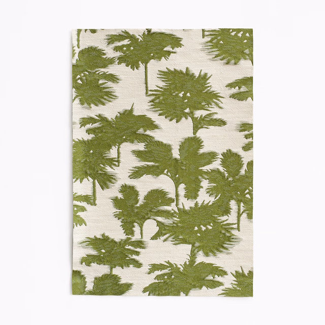 Muted cactus-green fern silhouettes over an ivory jacquard weave