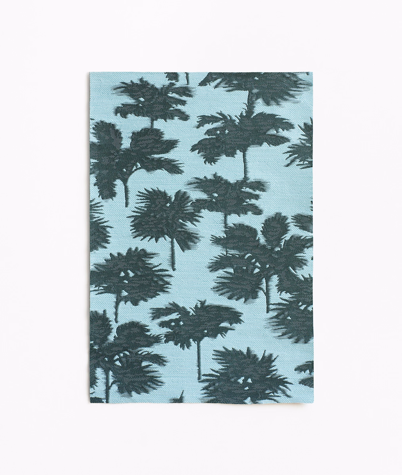 Pale aqua jacquard with dense dark teal palm silhouettes and visible woven texture