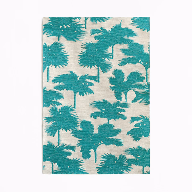 Turquoise palm silhouettes scattered across an ivory jacquard fabric swatch