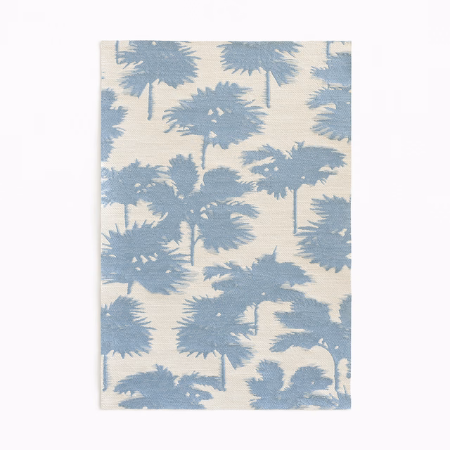 Powder-blue palm silhouettes scattered across a softly textured ivory jacquard