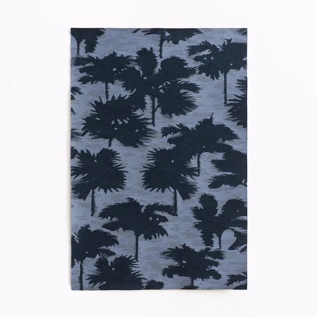 Slate blue jacquard with layered dark palm silhouettes and a subtly woven surface