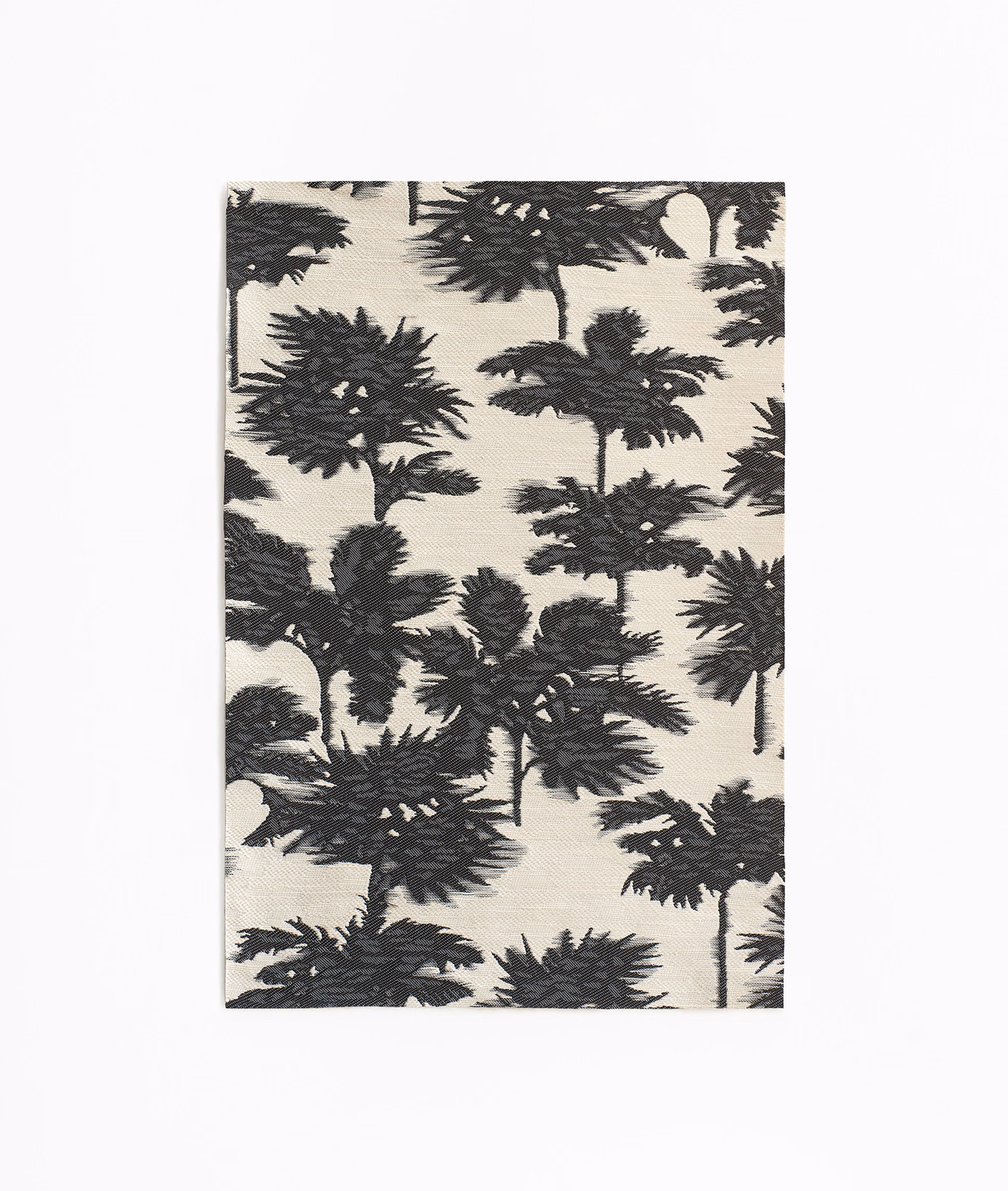 Ivory jacquard swatch with dense charcoal palm silhouettes and textured woven foliage