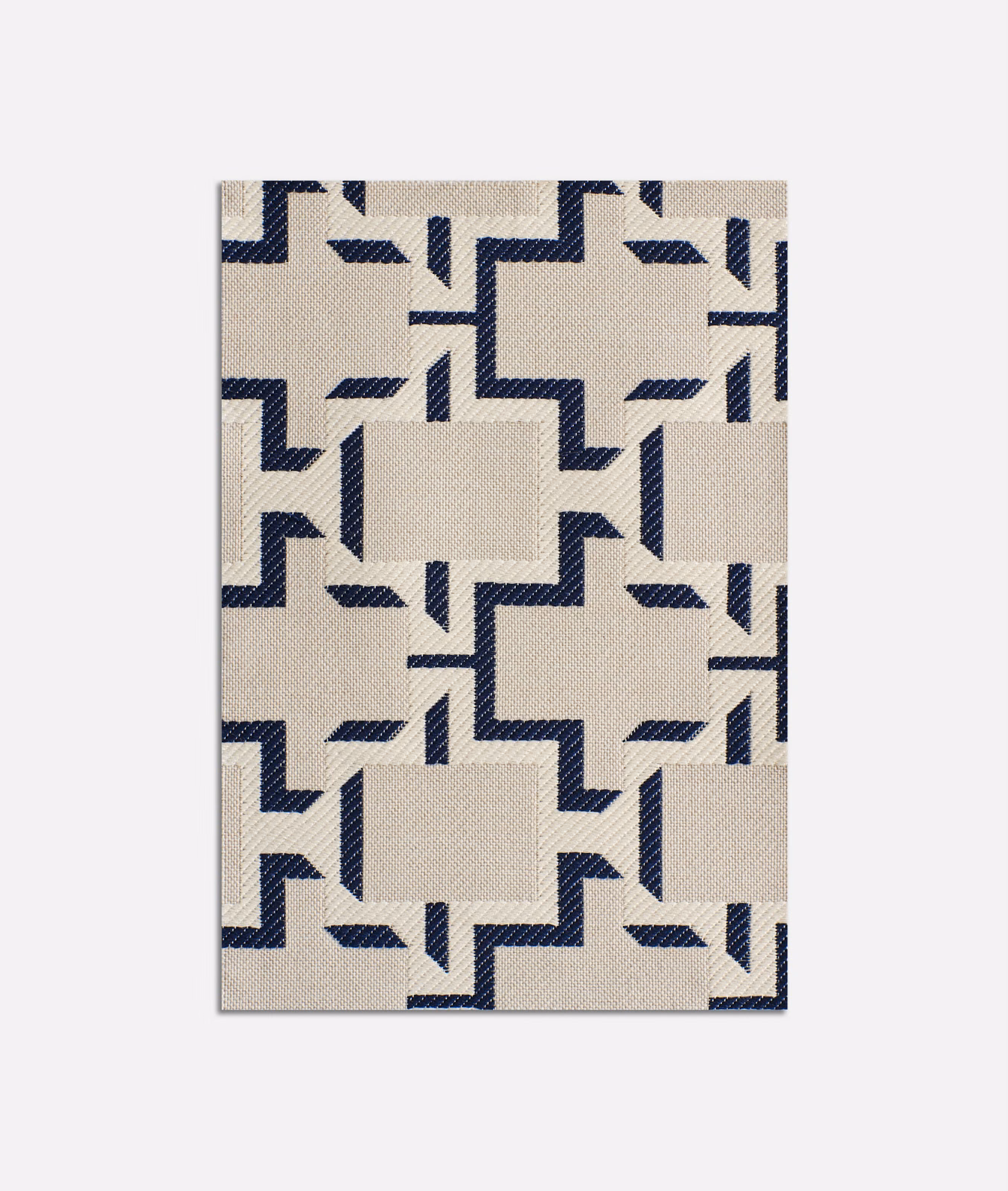 Ivory jacquard swatch with ink-blue stepped geometric motifs and fine woven texture