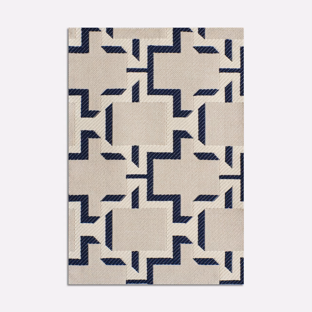 Ivory jacquard swatch with ink-blue stepped geometric motifs and fine woven texture