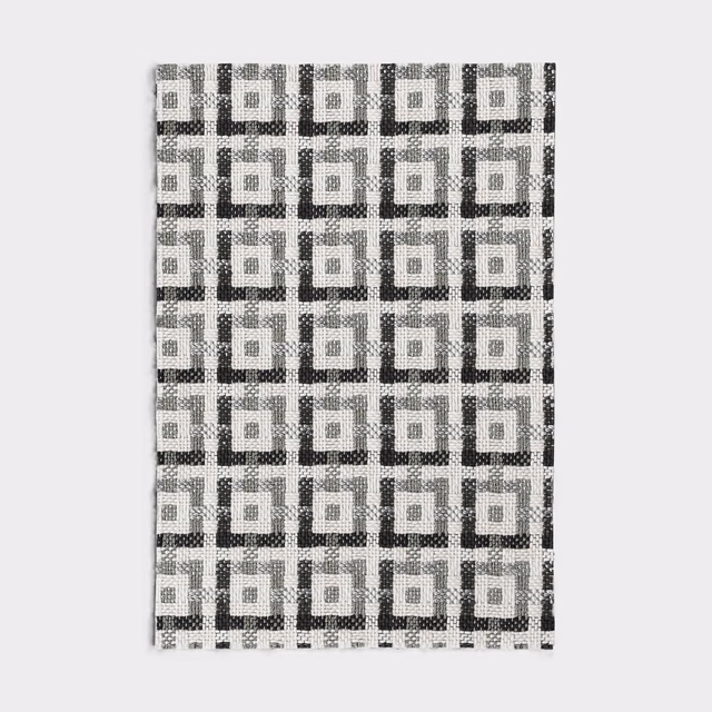 Silver-grey jacquard with black and white interlocking squares and a tactile weave