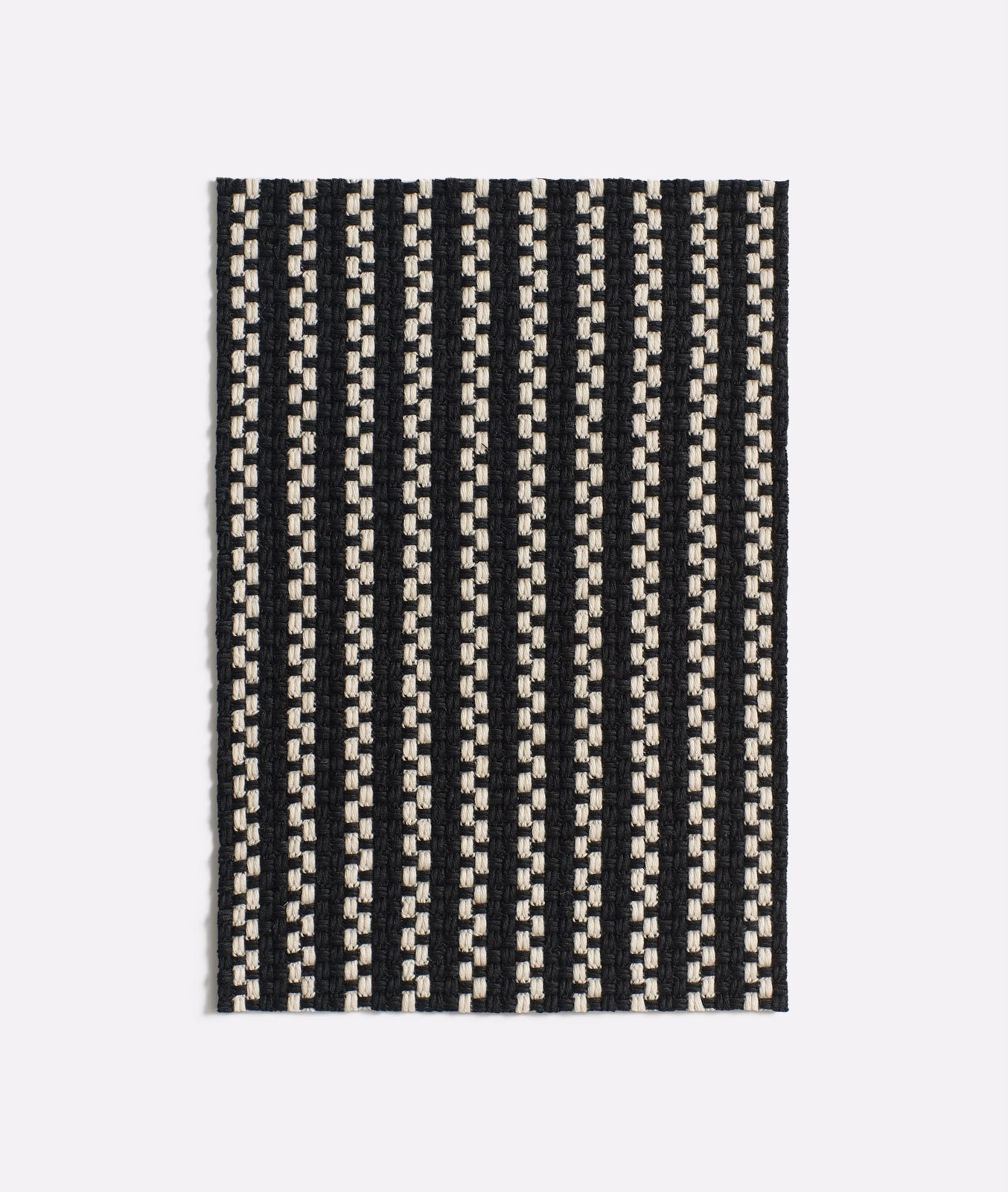 Black-and-cream jacquard swatch with narrow broken vertical stripes and raised texture