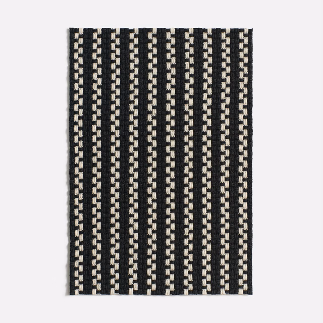 Black-and-cream jacquard swatch with narrow broken vertical stripes and raised texture