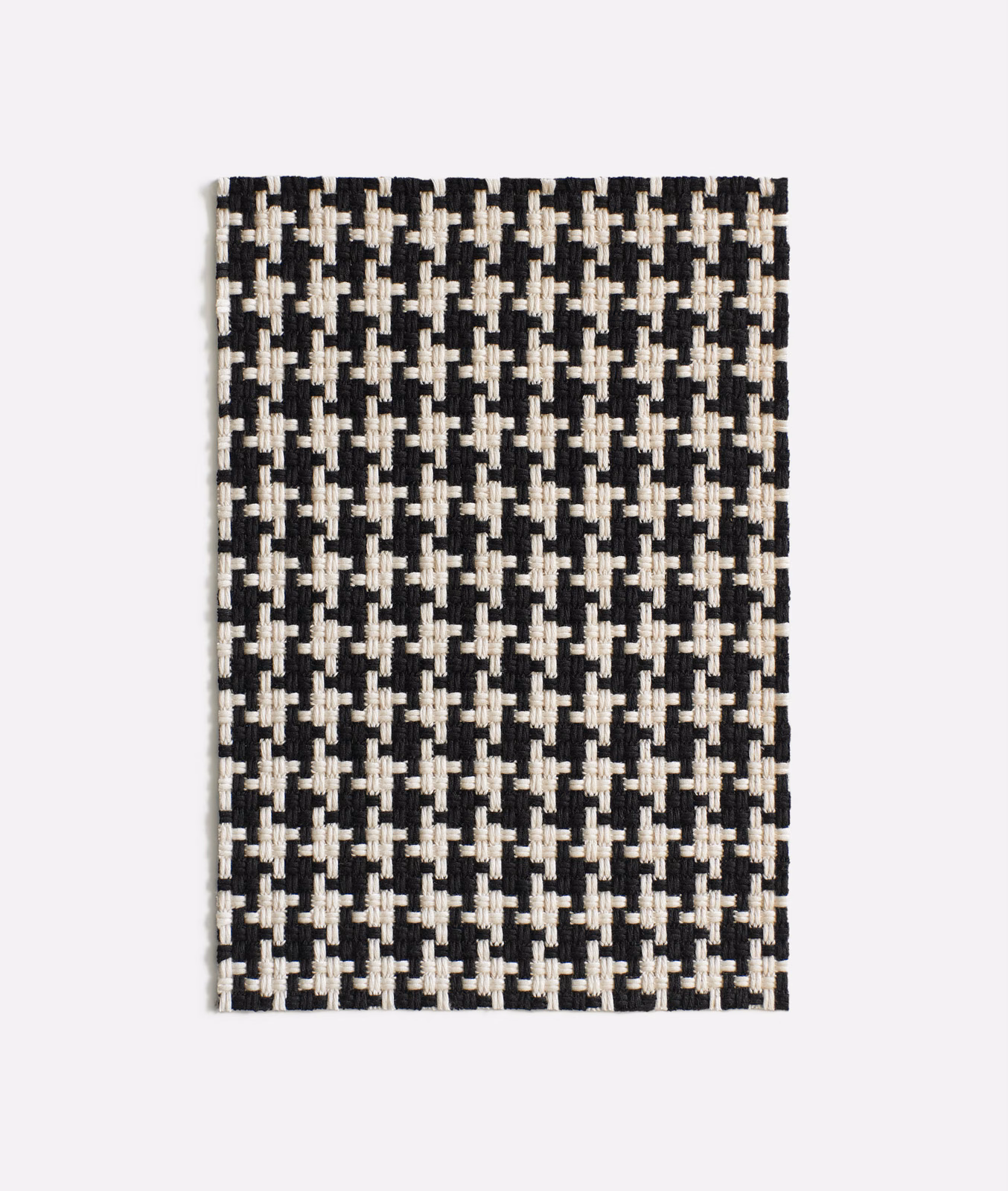 Black and ivory geometric jacquard with a dense, raised woven texture