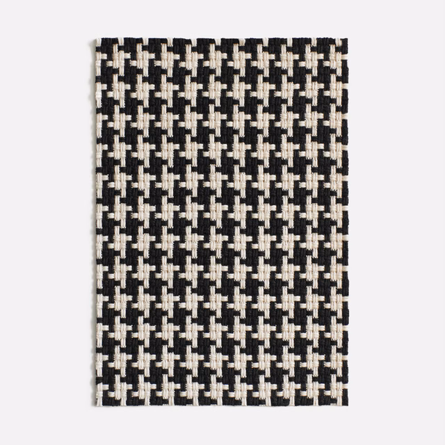 Black and ivory geometric jacquard with a dense, raised woven texture