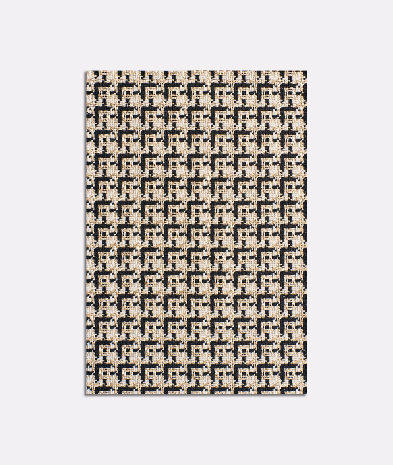 Ivory and charcoal jacquard with small interlocking geometric motifs and tactile woven variation