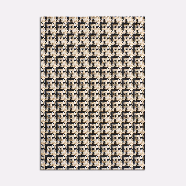 Ivory and charcoal jacquard with small interlocking geometric motifs and tactile woven variation