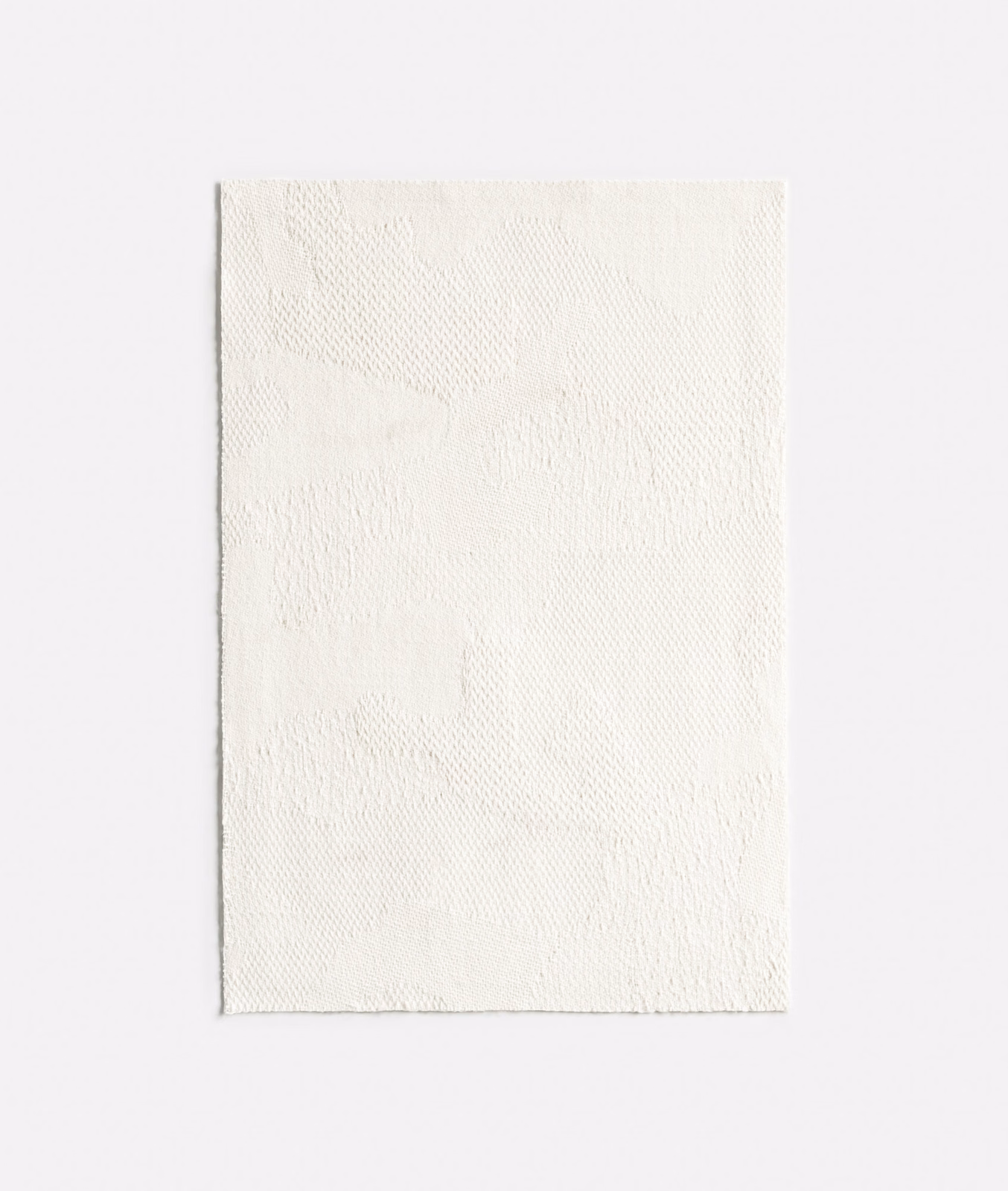 Ivory jacquard swatch with a faint abstract tonal motif and rippled texture