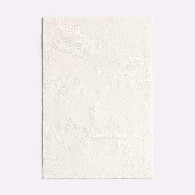 Ivory jacquard swatch with a faint abstract tonal motif and rippled texture