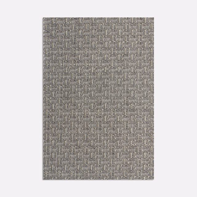 Warm stone-grey jacquard swatch with dense small stepped geometric weave