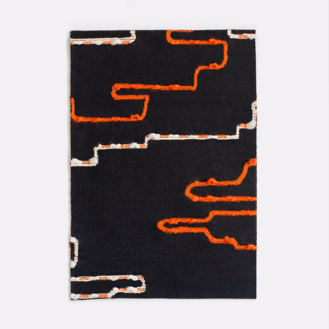 Black jacquard with vivid orange meanders and broken white geometric lines