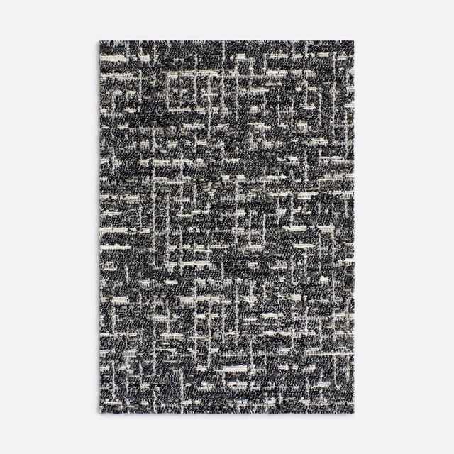 Charcoal and ivory jacquard with broken linear marks and a nubby woven surface