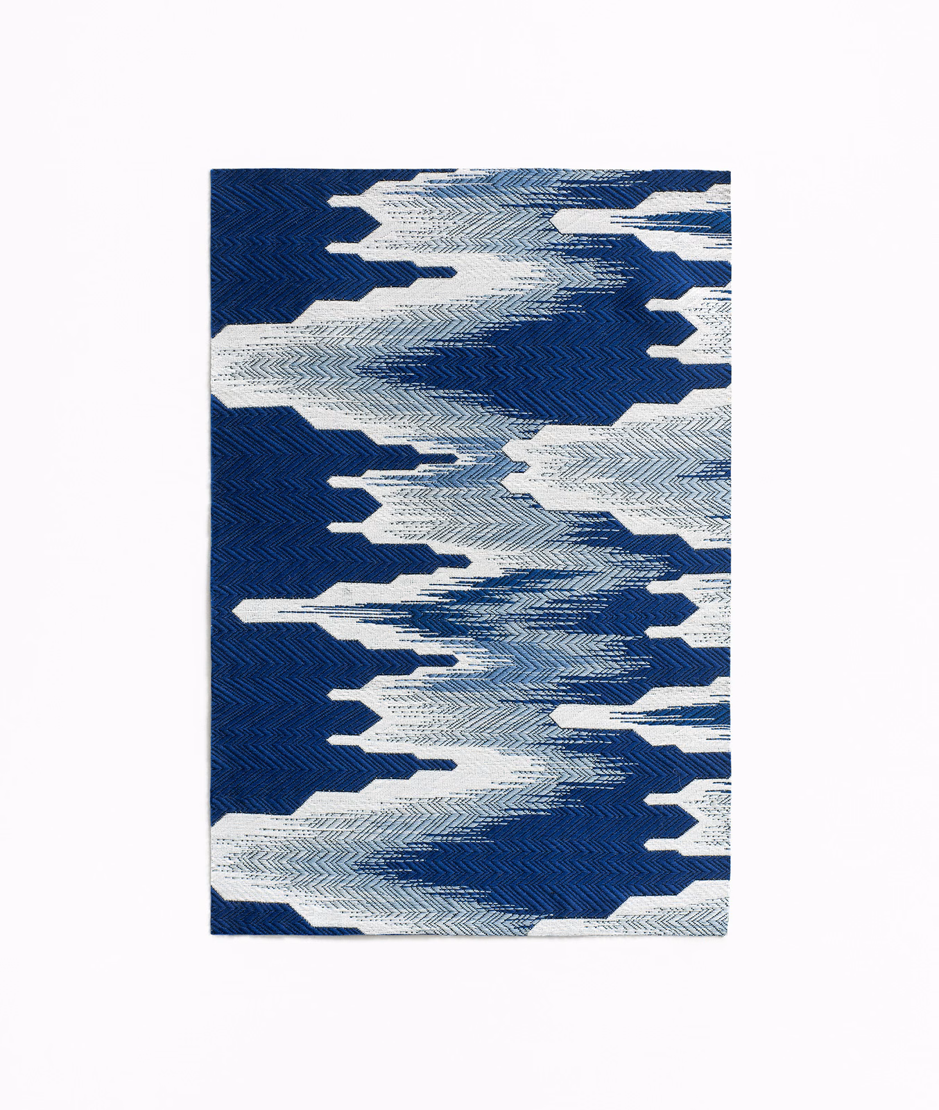 Deep indigo jacquard with ivory chevrons forming bold, broken horizontal bands