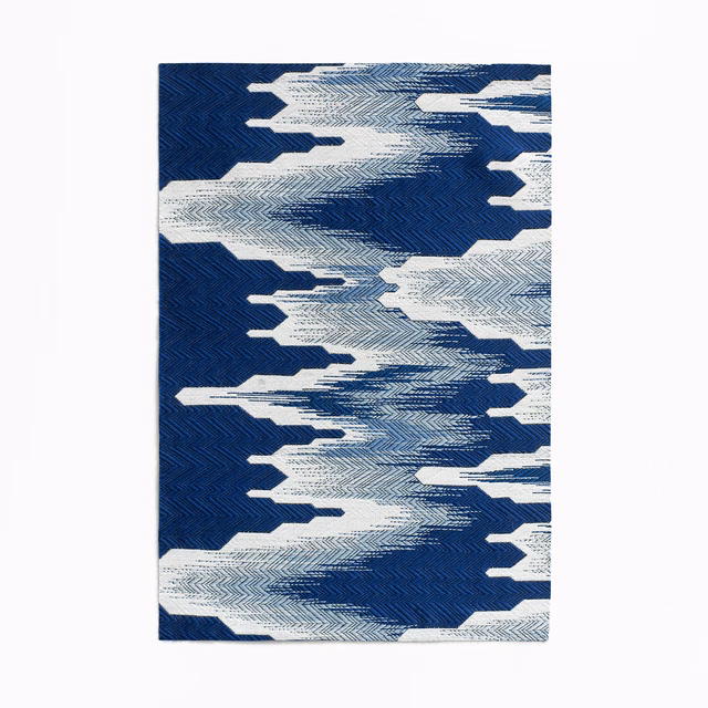 Deep indigo jacquard with ivory chevrons forming bold, broken horizontal bands