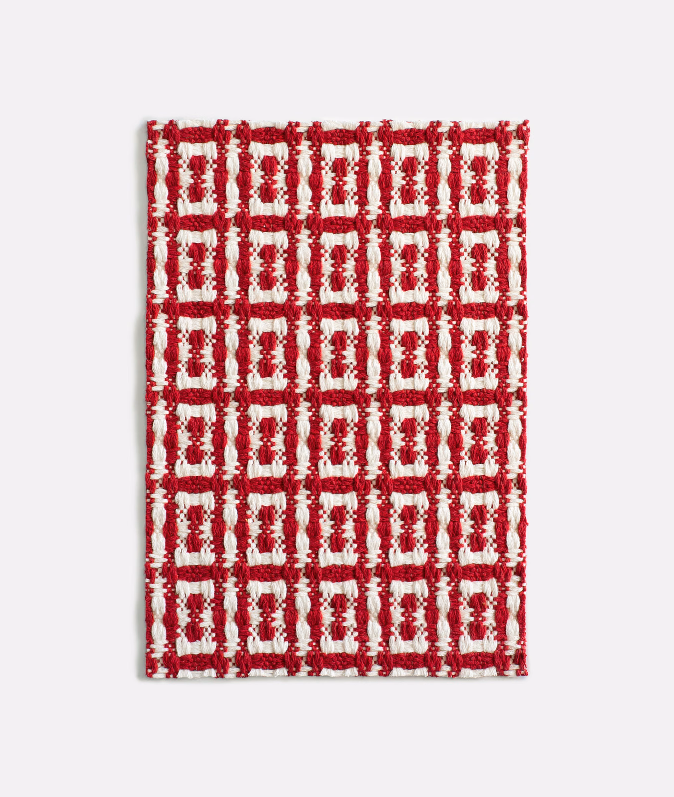 Cherry-red and cream raised geometric grid with chunky jacquard texture