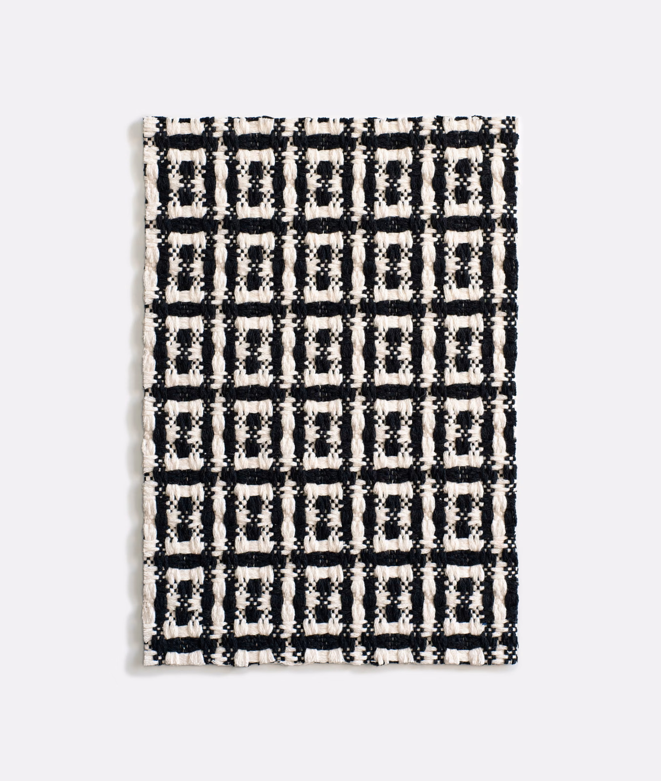 Black and ivory chunky jacquard with a tactile rectangular grid pattern