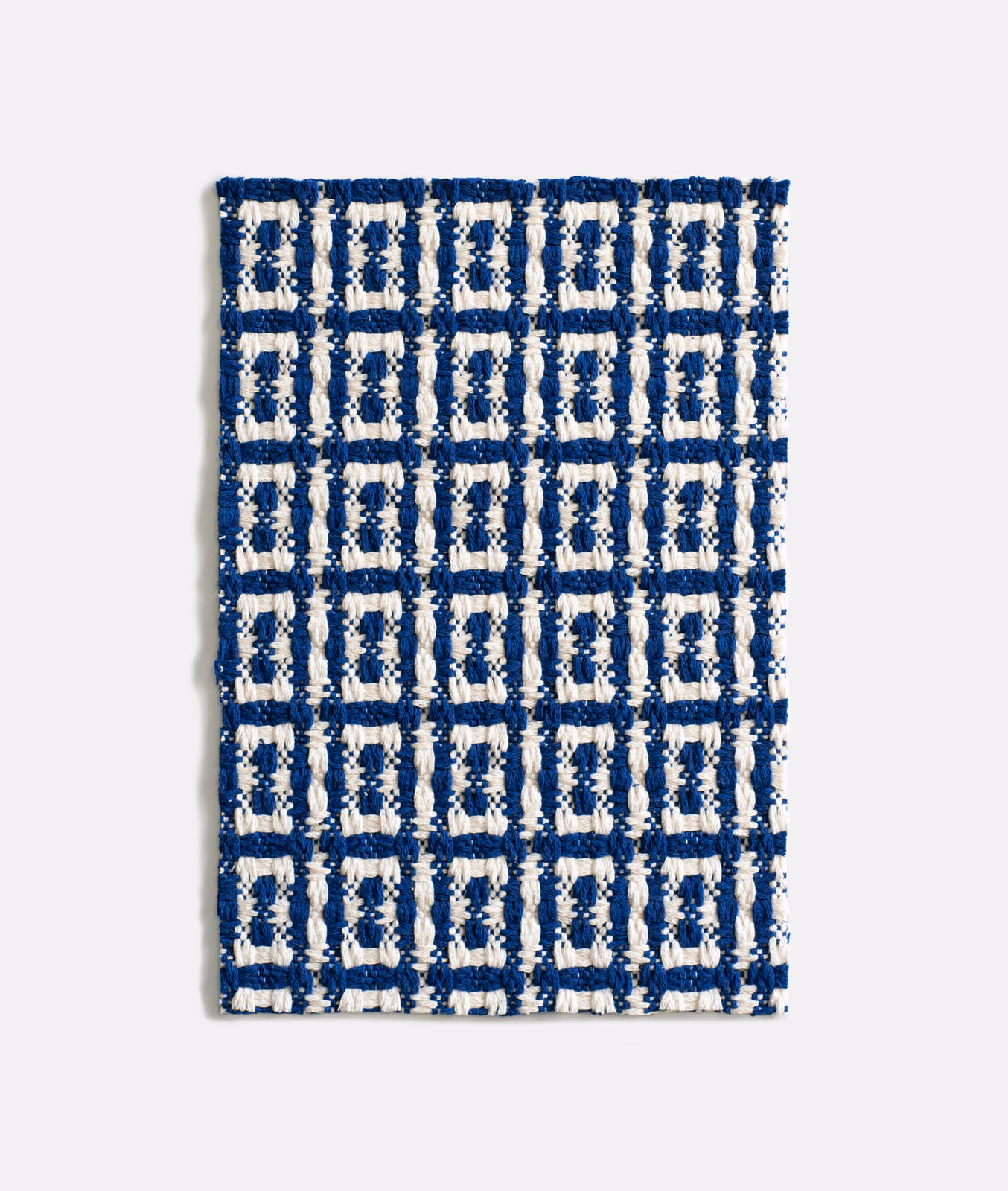 Deep navy jacquard with chunky cream geometric grid and raised textured weave
