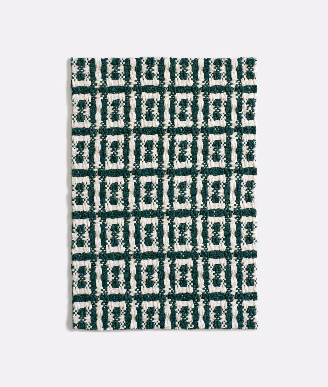 Forest green and ivory geometric jacquard with a raised, irregular checked weave