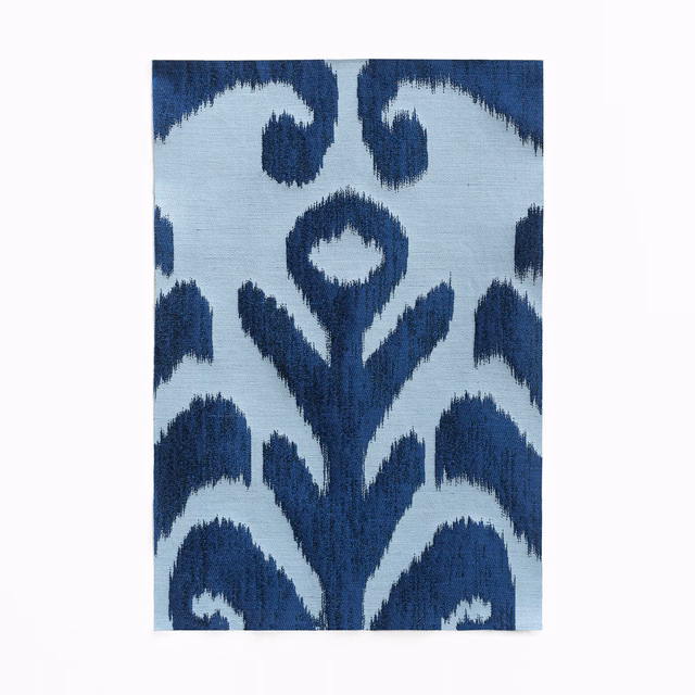 Icy pale-blue jacquard with deep navy ikat floral forms and feathery woven edges
