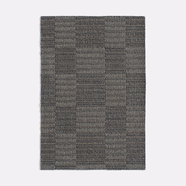 Charcoal-grey jacquard swatch with tactile weave and irregular rectangular blocks