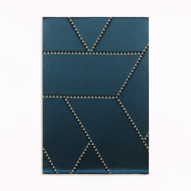 Deep blue jacquard with angular triangular-edged bands in a close-up swatch